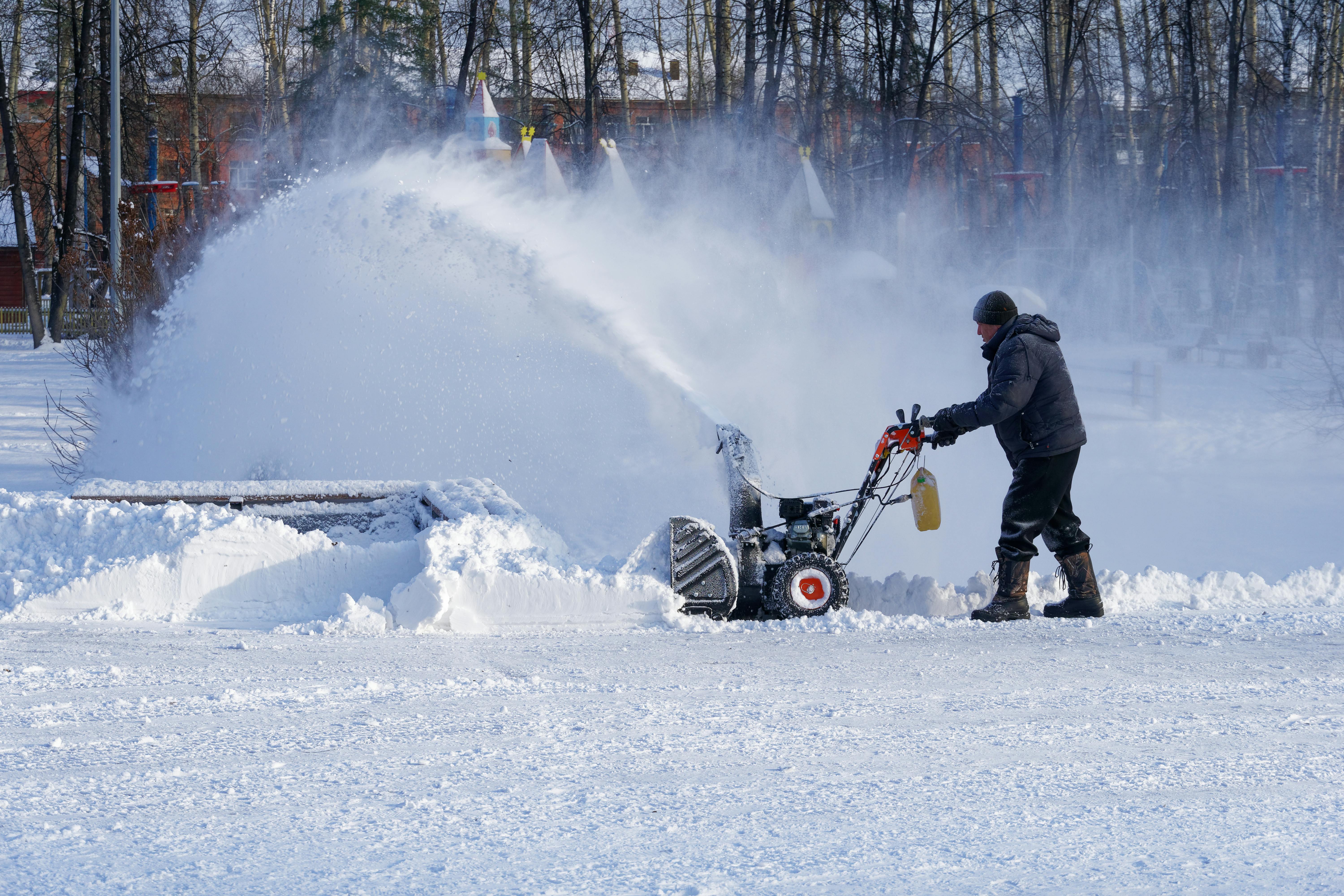 Snow blower clearing light snow from a driveway